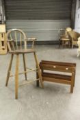 A CHILD'S HARDWOOD HOOP BACK HIGH CHAIR WITH ARMS AND A PERIODICAL RACK