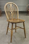 A SET OF FOUR HARDWOOD WHEEL BACK SINGLE CHAIRS WITH PANEL SEATS