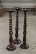 THREE MATCHING TURNED AND CARVED WOODEN PEDESTALS