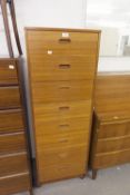 A TEAK EFFECT TALLBOY CHEST OF DRAWERS