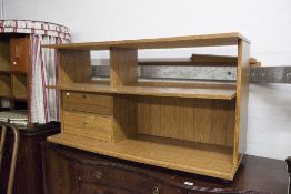 A TEAK EFFECT LOW SHELVING UNIT WITH TWO SHORT DRAWERS AND A KIDNEY SHAPED DRESSING TABLE WITH