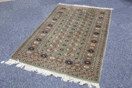 PAKISTAN BOKHARA RUG with two rows of guls on a green field, multiple border stripes, 5' x 3' 2" (