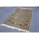 PAKISTAN BOKHARA RUG with two rows of guls on a green field, multiple border stripes, 5' x 3' 2" (