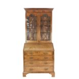 GEORGE III MAHOGANY BUREAU, with later bookcase top, the bureau of typical form with four