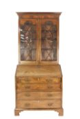 GEORGE III MAHOGANY BUREAU, with later bookcase top, the bureau of typical form with four