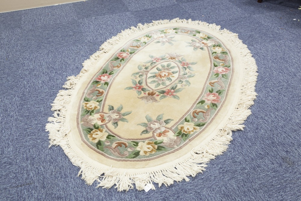 HAND-KNOTTED WASHED CHINESE OVAL RUG of Aubusson design with oval centre floral medallion on a plain - Image 2 of 2