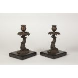 PAIR OF EARLY TWENTIETH CENTURY COPPER PLATED CANDLESTICKS, each modelled as a mythical fish with
