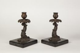 PAIR OF EARLY TWENTIETH CENTURY COPPER PLATED CANDLESTICKS, each modelled as a mythical fish with