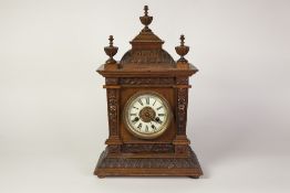 EARLY TWENTIETH CENTURY H.A.C., GERMANY CARVED WALNUTWOOD MANTEL CLOCK, the 4" Roman dial with