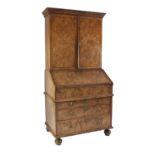 QUEEN ANNE FIGURED WALNUTWOOD BUREAU CABINET, the moulded cornice above a pair of quarter cut and