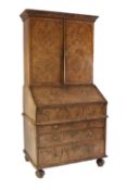 QUEEN ANNE FIGURED WALNUTWOOD BUREAU CABINET, the moulded cornice above a pair of quarter cut and