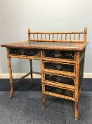 LATE 19th CENTURY BAMBOO SINGLE PEDESTAL DESK with five drawers, having spandled gallery back,