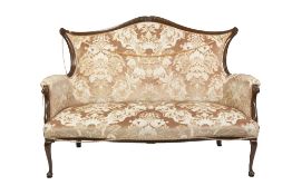 EARLY TWENTIETH CENTURY WALNUTWOOD TWO SEATER SETTEE, the arched, padded back with shell and