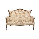 EARLY TWENTIETH CENTURY WALNUTWOOD TWO SEATER SETTEE, the arched, padded back with shell and