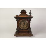 EARLY TWENTIETH CENTURY CONTINENTAL WALNUTWOOD CASED MANTEL CLOCK, the 5 1/4" brass Arabic dial with
