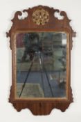 GEORGE III MAHOGANY AND PARCEL GILT WALL MIRROR, the oblong plate in a moulded frame with pierced