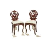 PAIR OF NINETEENTH CENTURY CARVED MAHOGANY HALL CHAIRS, each with circular pierced central panel and