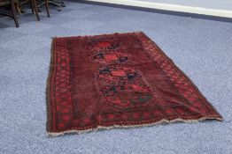 SEMI ANTIQUE AFGHAN ERSARI RUG, crimson with stencilled black design of four large octagonal guls,