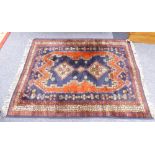 EASTERN RUG, with triple diamond pattern, pole medallion, on a dark blue field with irregular red,
