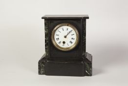 LATE VICTORIAN BLACK SLATE MANTEL CLOCK, the 3 1/2" enamelled Roman dial powered by a drum shaped