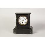 LATE VICTORIAN BLACK SLATE MANTEL CLOCK, the 3 1/2" enamelled Roman dial powered by a drum shaped