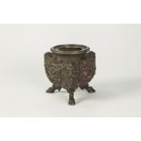 EMBOSSED BRONZE GLOBULAR BOWL, the exterior decorated with fruiting vines and three satyr mask
