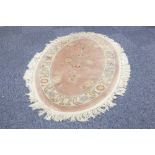 PAIR OF WASHED CHINESE ALL WOOL OVAL RUGS with an embossed circular centre floral medallion and