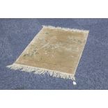 WASHED CHINESE PART SILK RUG with a pale gold field decorated with a diagonal naturalistic