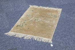 WASHED CHINESE PART SILK RUG with a pale gold field decorated with a diagonal naturalistic