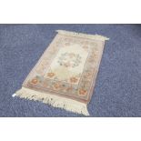 THREE HEAVY QUALITY HAND-KNOTTED WASHED CHINESE OBLONG RUGS of embossed Aubusson design, one with an