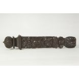 ANTIQUE CARVED DARK OAK PANEL OR CAPPING PIECE, decorated with stylized masks and flower heads,