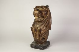 ORIENTAL CARVED GILTWOOD MODEL OF A LIONS HEAD, on an oblong scroll carved and ebonised base, 18" (