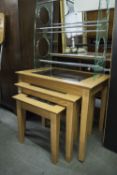 A NEST OF THREE LIGHT OAK OBLONG COFFEE TABLES, WITH INSET PLATE GLASS TOPS