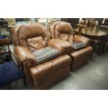 A PAIR OF ELECTRICAL OPERATED RECLINING ARMCHAIRS, COVERED IN TAN HIDE