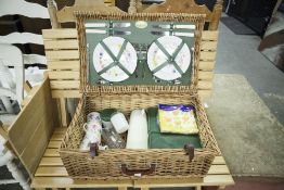 A WICKER PICNIC HAMPER FITTED WITH CONTENTS, FOR FOUR PERSONS AND A COLLAPSIBLE PICNIC TABLE AND TWO