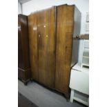 A VICTORIAN WALNUT BEDROOM SUITE COMPRISING; DRESSING TABLE WITH SHAPED TRIPLE MIRROR AND WARDROBE