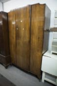 A VICTORIAN WALNUT BEDROOM SUITE COMPRISING; DRESSING TABLE WITH SHAPED TRIPLE MIRROR AND WARDROBE