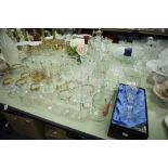 A COLLECTION OF CUT GLASS AND GILT DRINKING GLASSES, VIZ CHAMPAGNE FLUTES, WINES, BRANDY BALLOONS,