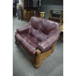A RED LEATHER TWO SEATER SETTEE WITH DRAWERS BELOW FOR STORAGE