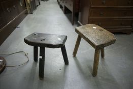 TWO OLD THREE-LEGGED MILKING STOOLS