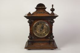 EARLY TWENTIETH CENTURY CONTINENTAL WALNUTWOOD CASED MANTEL CLOCK, the 5 1/4" brass Arabic dial with
