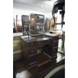 EARLY TWENTIETH CENTURY CHILD'S OAK DRESSING TABLE, with bevel cut triptych mirrors, 28 3/4" high,