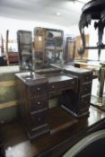 EARLY TWENTIETH CENTURY CHILD'S OAK DRESSING TABLE, with bevel cut triptych mirrors, 28 3/4" high,
