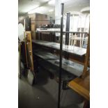 A BLACK TUBULAR METAL FRAME FOUR TIER SHELVING UNIT