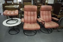 A PAIR OF 1960's ROTATING EASY ARMCHAIRS, COVERED IN CORAL COLOURED LEATHER ON BLACK METAL