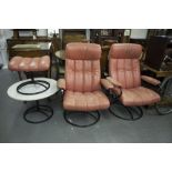 A PAIR OF 1960's ROTATING EASY ARMCHAIRS, COVERED IN CORAL COLOURED LEATHER ON BLACK METAL