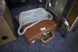 A LADY'S ESCAMA STUDIO ALUMINUM LINK PATTERN HANDBAG AND A 'SKYFLITE' TAN COLOURED ATTACHÉ CASE WITH