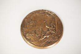 EMBOSSED GILT METAL CIRCULAR PLAQUE, decorated with a religious scene depicting a reclining