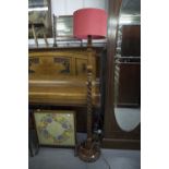 AN OAK SPIRAL STANDARD LAMP (A.F.), A GRATESCREEN WITH GLAZED AND NEEDLEWORK PANEL (2)