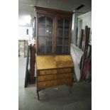 AN EARLY TWENTIETH CENTURY BUREAU BOOKCASE, THE GLAZED TWO DOOR TOP ENCLOSING TWO SHELVES, THE